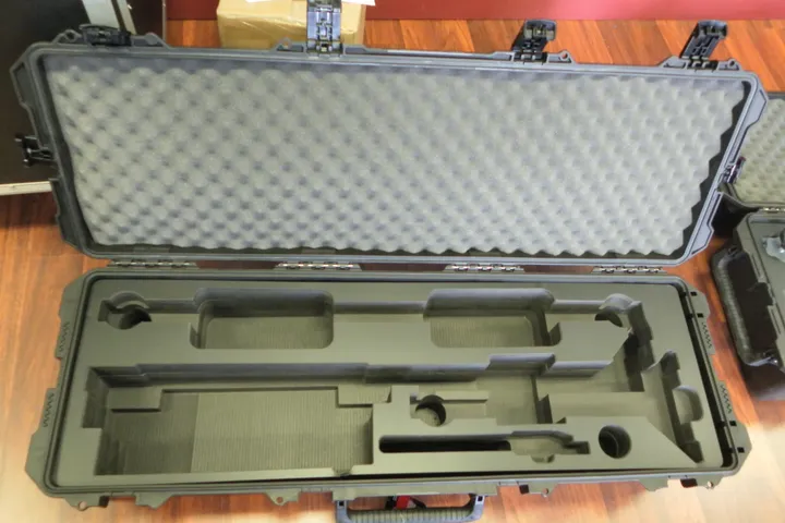 Gun foam insert cut for a rifle in an olive drab Pelican long case